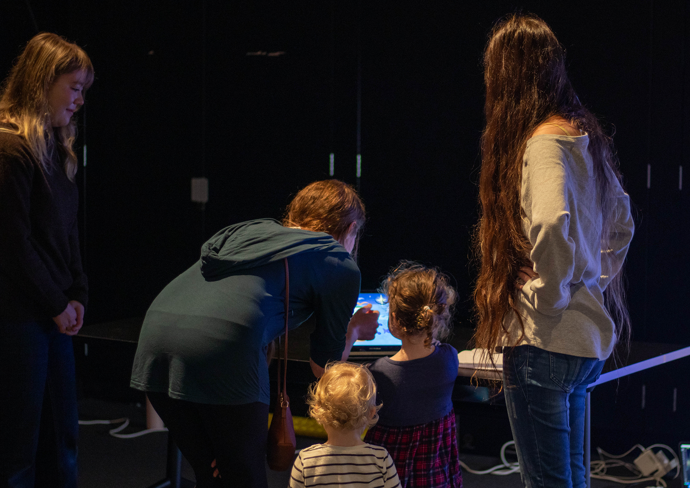 Visitors interacting with the Upright Rainbow exhibition at MOTAT