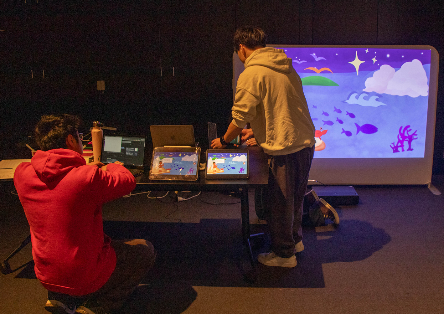 Team members testing the interactive projector setup
